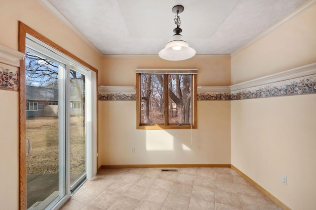 unfurnished dining area with visible vents, baseboards, and ornamental molding