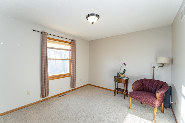 sitting room featuring visible vents, baseboards, and carpet