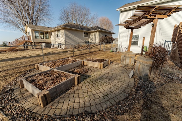 view of patio with a vegetable garden and fence