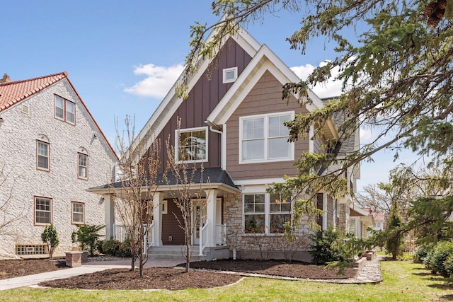 38 Mississippi River Blvd N, Saint Paul, MN 55104 - craftsman inspired home with board and batten siding, stone siding, a front yard, and a porch