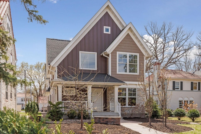 38 Mississippi River Blvd N, Saint Paul, MN 55104 - view of front of house featuring board and batten siding, a porch, stone siding, and roof with shingles