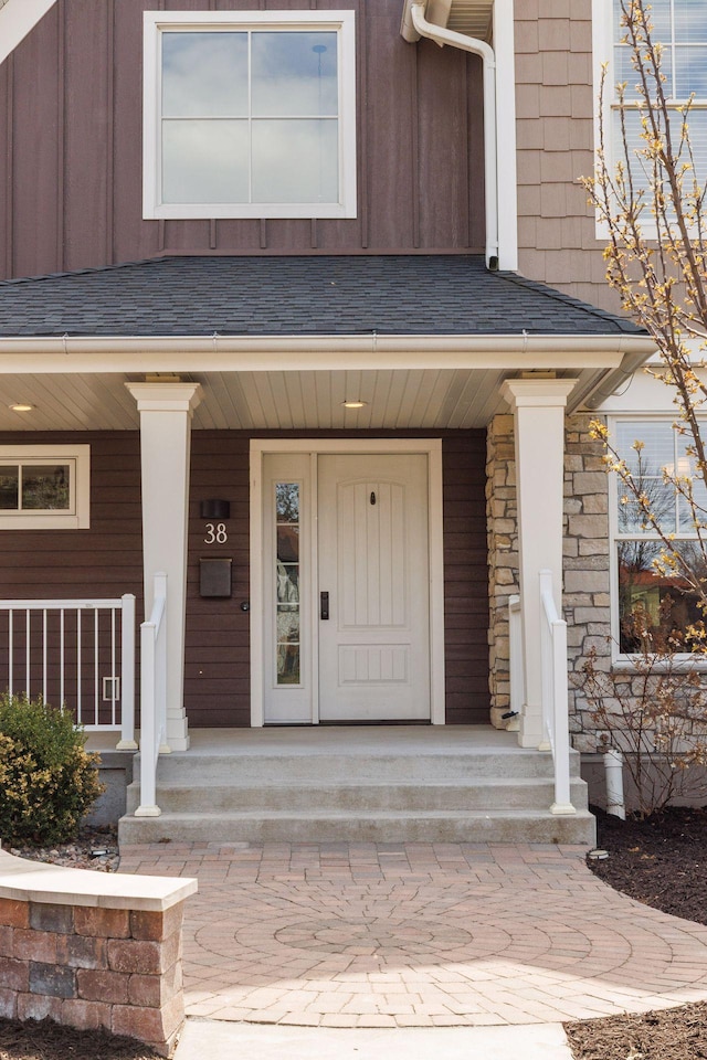 38 Mississippi River Blvd N, Saint Paul, MN 55104 - doorway to property featuring a porch, board and batten siding, and stone siding