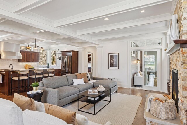 38 Mississippi River Blvd N, Saint Paul, MN 55104 - living room featuring light wood-style floors, beam ceiling, a stone fireplace, and recessed lighting