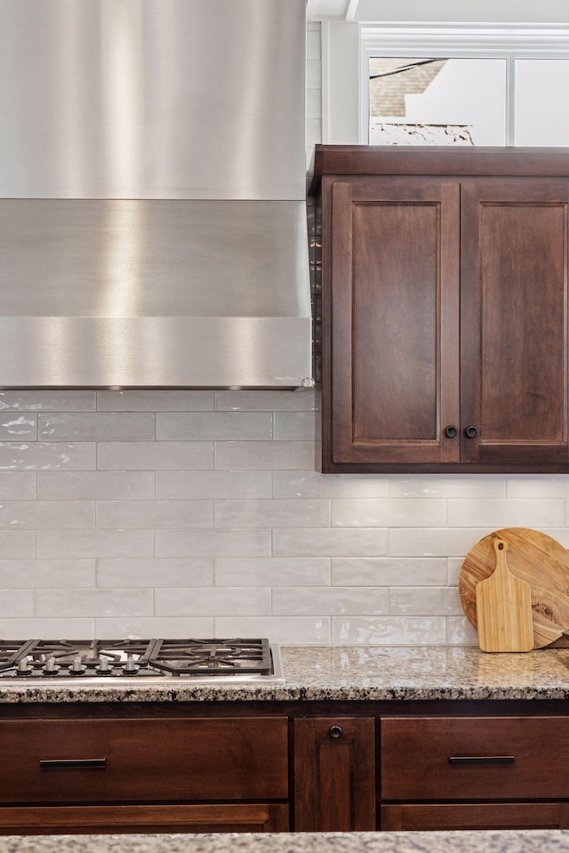 38 Mississippi River Blvd N, Saint Paul, MN 55104 - kitchen featuring extractor fan, tasteful backsplash, stainless steel gas cooktop, and dark brown cabinets