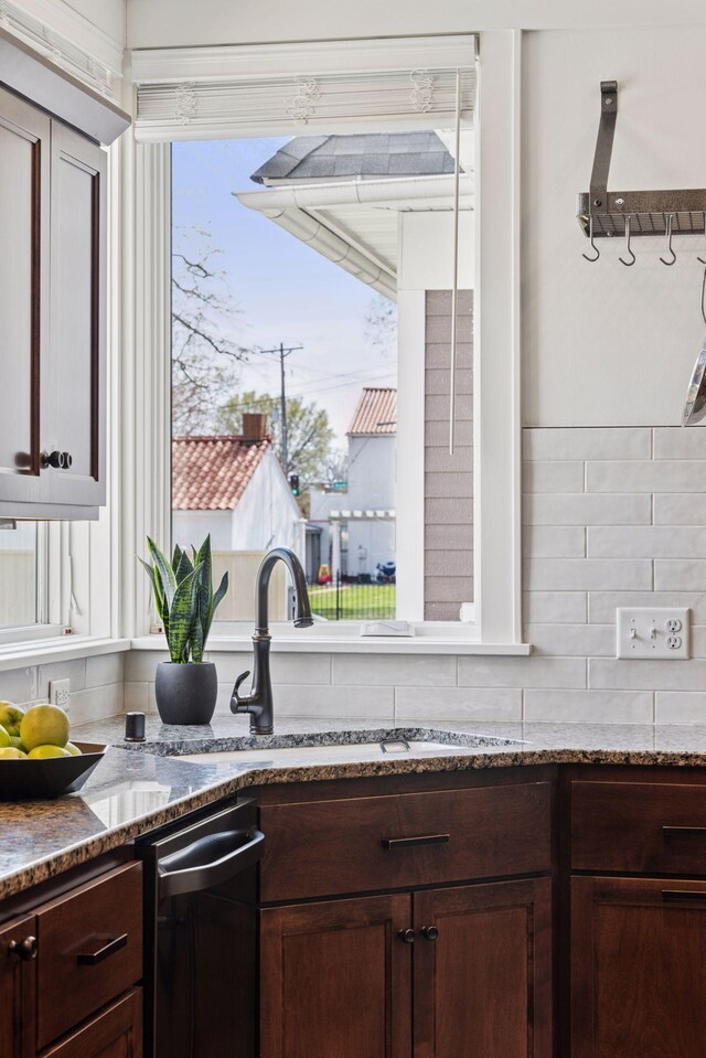 38 Mississippi River Blvd N, Saint Paul, MN 55104 - kitchen featuring stone countertops, decorative backsplash, dishwasher, dark brown cabinets, and a sink