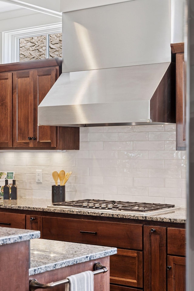 38 Mississippi River Blvd N, Saint Paul, MN 55104 - kitchen with wall chimney exhaust hood, backsplash, light stone counters, and stainless steel gas stovetop