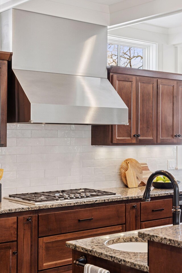 38 Mississippi River Blvd N, Saint Paul, MN 55104 - kitchen with wall chimney exhaust hood, stainless steel gas cooktop, a sink, and decorative backsplash