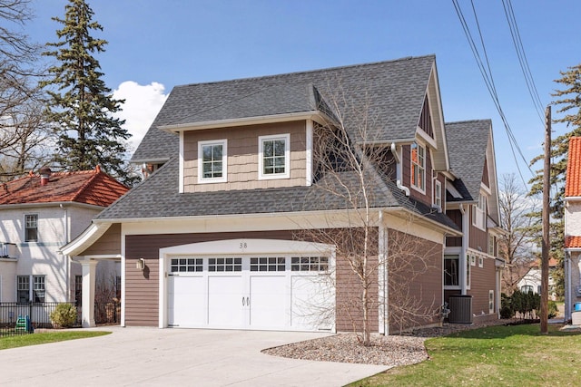 38 Mississippi River Blvd N, Saint Paul, MN 55104 - view of home's exterior featuring roof with shingles, driveway, cooling unit, and an attached garage