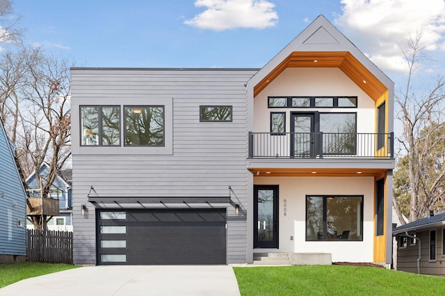 6008 Oaklawn Ave, Edina, MN 55424 - contemporary home with a balcony, driveway, an attached garage, and stucco siding