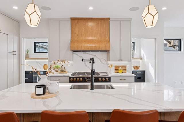 6008 Oaklawn Ave, Edina, MN 55424 - kitchen featuring extractor fan, recessed lighting, an island with sink, white cabinets, and a kitchen breakfast bar