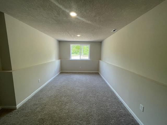 16839 Piper Ln, Brainerd, MN 56401 - carpeted empty room with a textured ceiling, recessed lighting, and baseboards