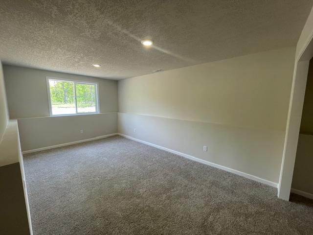 16839 Piper Ln, Brainerd, MN 56401 - carpeted spare room featuring a textured ceiling, baseboards, and recessed lighting