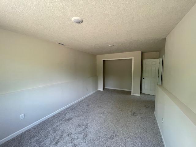 16839 Piper Ln, Brainerd, MN 56401 - carpeted spare room featuring a textured ceiling and baseboards