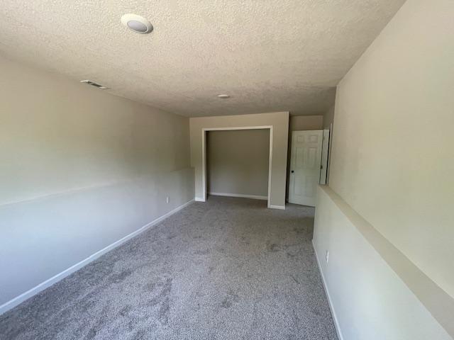 16839 Piper Ln, Brainerd, MN 56401 - hallway featuring a textured ceiling, carpet flooring, and baseboards