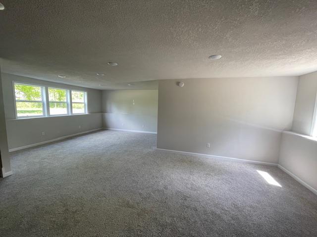 16839 Piper Ln, Brainerd, MN 56401 - spare room with carpet, a textured ceiling, and baseboards