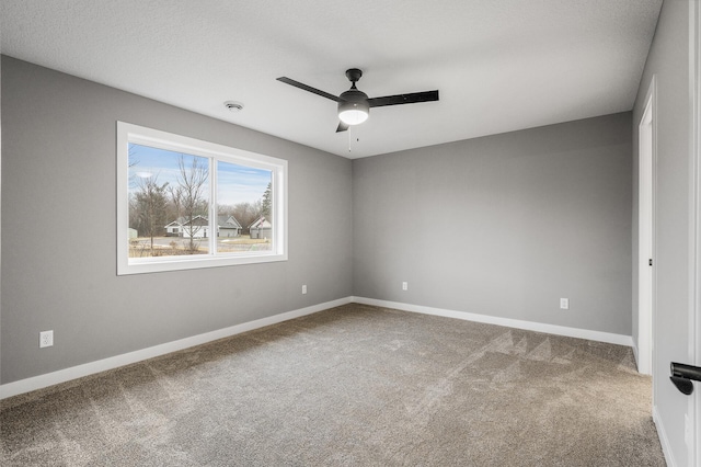 empty room with baseboards, carpet, and ceiling fan