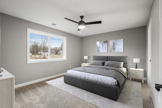 bedroom with a ceiling fan, carpet, and baseboards