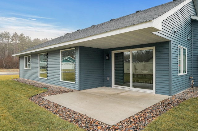 rear view of property featuring a yard and a patio area