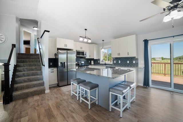 18492 120th St SE, Big Lake, MN 55309 - kitchen featuring stainless steel appliances, decorative backsplash, wood finished floors, and a center island