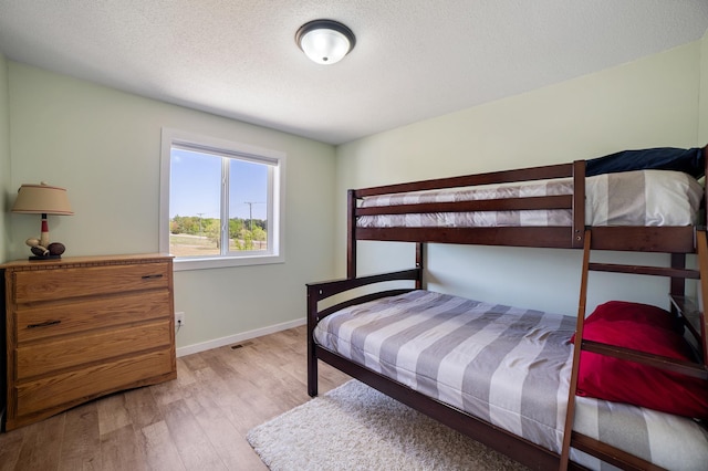 18492 120th St SE, Big Lake, MN 55309 - bedroom featuring light wood-style floors and a textured ceiling