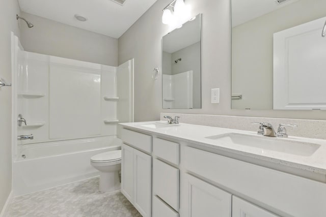 full bath with a sink, shower / tub combination, double vanity, and toilet