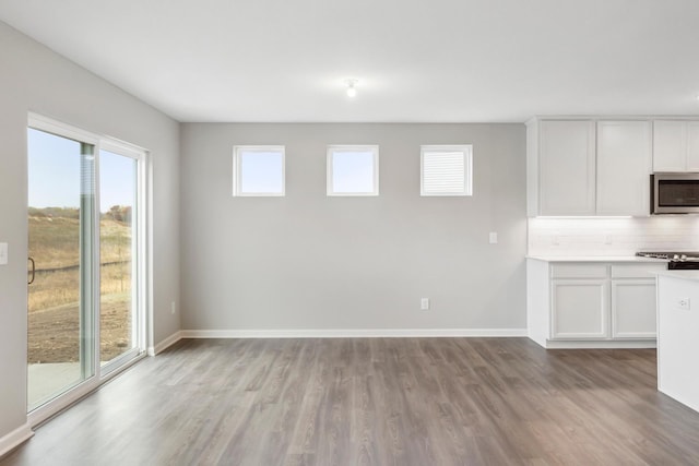 interior space featuring baseboards and light wood-style floors