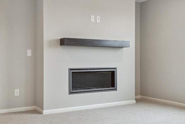 details featuring carpet flooring, a fireplace, and baseboards