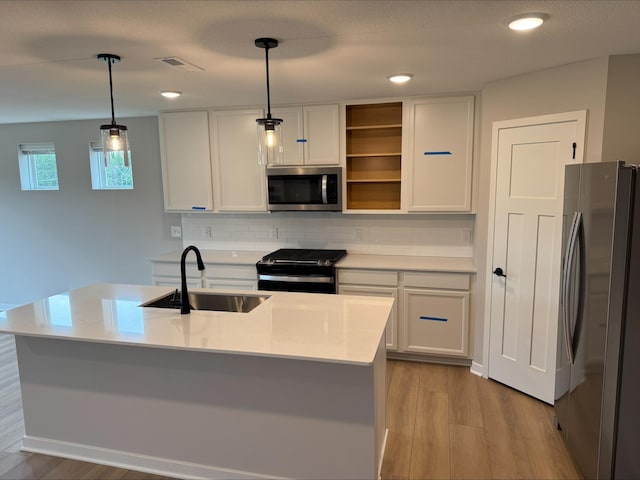 6255 Highland Hills Ln S, Cottage Grove, MN 55016 - kitchen featuring stainless steel appliances, a sink, wood finished floors, white cabinetry, and recessed lighting