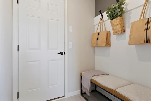 mudroom with light tile patterned flooring and baseboards