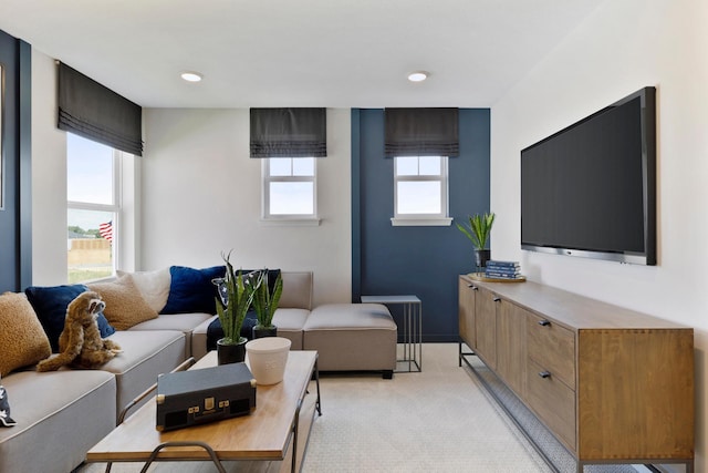 living room with recessed lighting, a healthy amount of sunlight, and light carpet