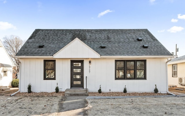 modern farmhouse style home featuring a shingled roof