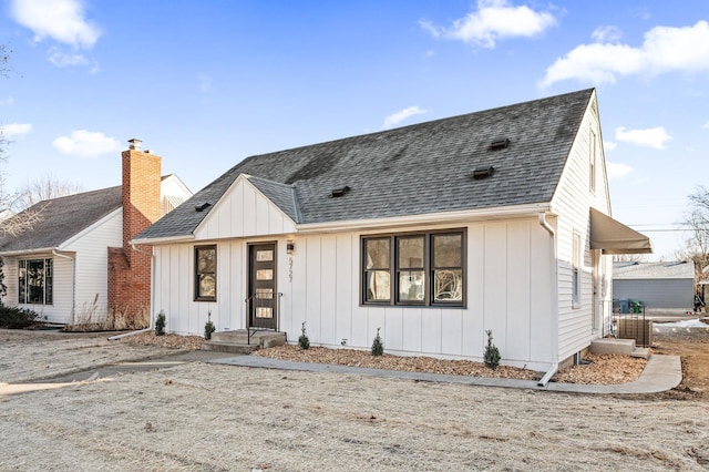 modern farmhouse with board and batten siding and roof with shingles