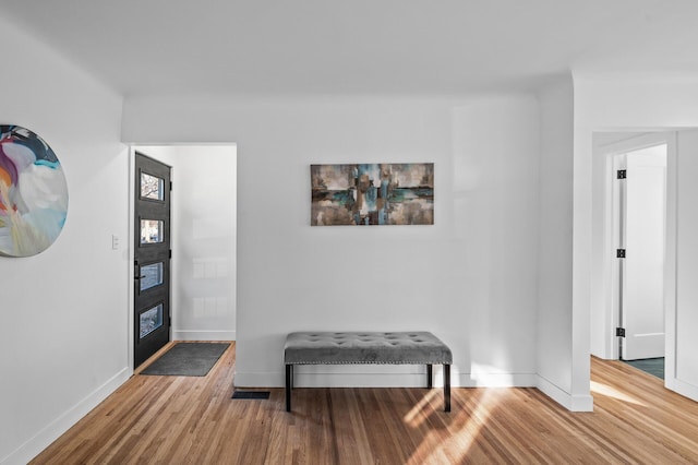 interior space with baseboards and wood finished floors