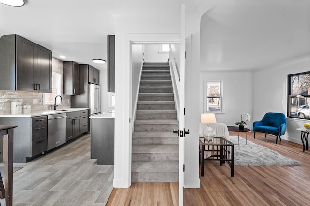 stairway with wood finished floors and baseboards