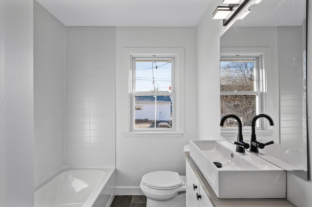 full bath featuring baseboards, toilet, a healthy amount of sunlight, and vanity