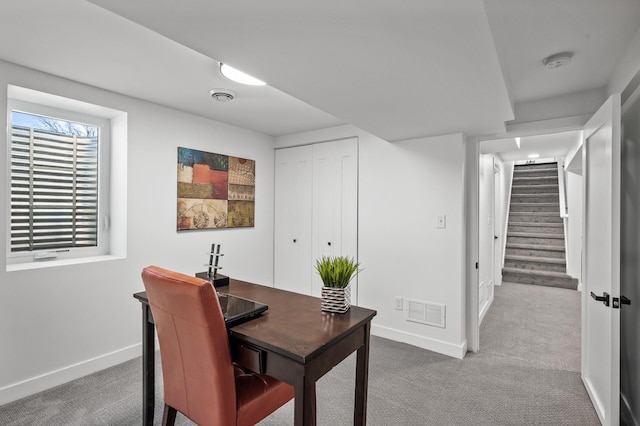 office area featuring visible vents, carpet flooring, and baseboards