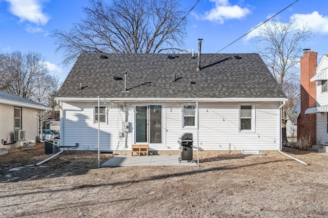 back of house featuring entry steps, a patio, cooling unit, and roof with shingles