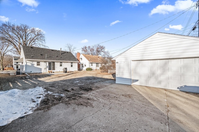 exterior space featuring an outbuilding and a detached garage