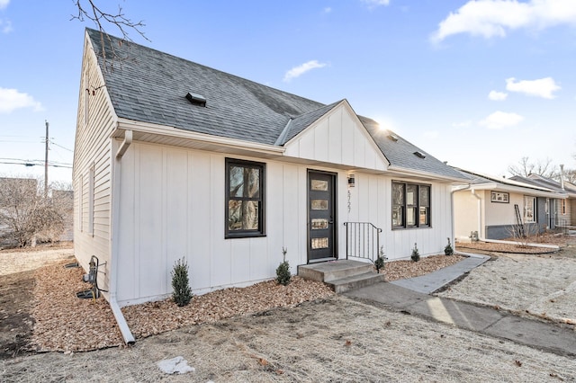 modern farmhouse featuring board and batten siding and a shingled roof