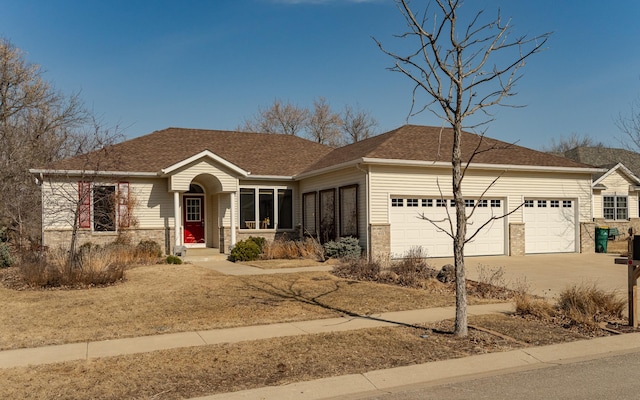 single story home featuring driveway, brick siding, an attached garage, and a shingled roof