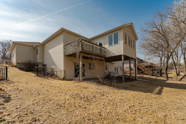 back of house featuring stairs and a deck