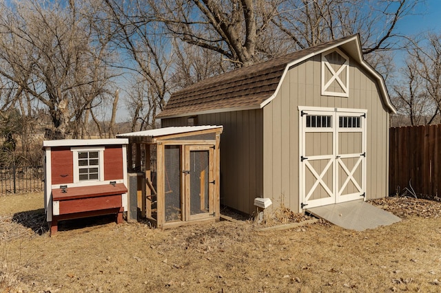 view of poultry coop featuring fence