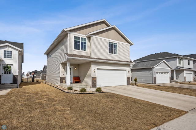 view of front of house with fence, driveway, a front lawn, stone siding, and a garage