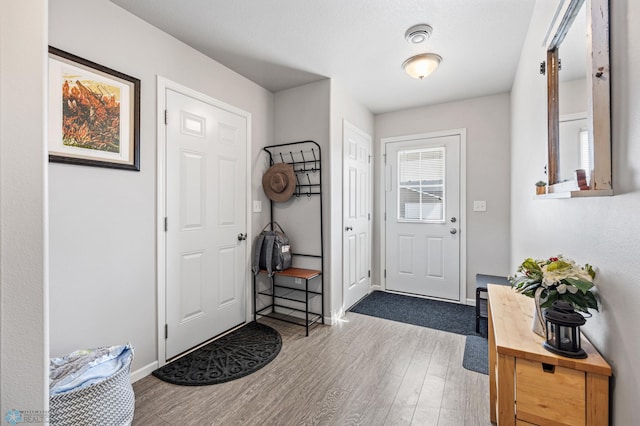 interior space with baseboards and wood finished floors