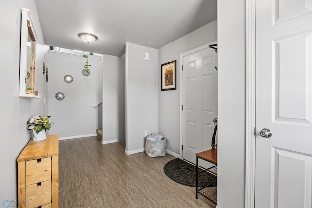 hall with stairway, baseboards, and wood finished floors