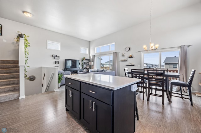 kitchen with light countertops, light wood-style floors, a wealth of natural light, and a center island