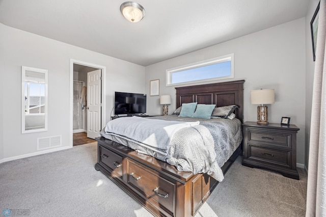 carpeted bedroom featuring baseboards and visible vents