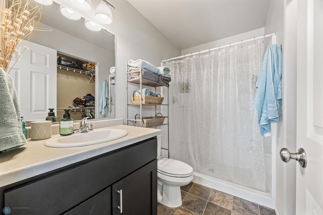 full bathroom with a shower stall, toilet, vanity, and baseboards