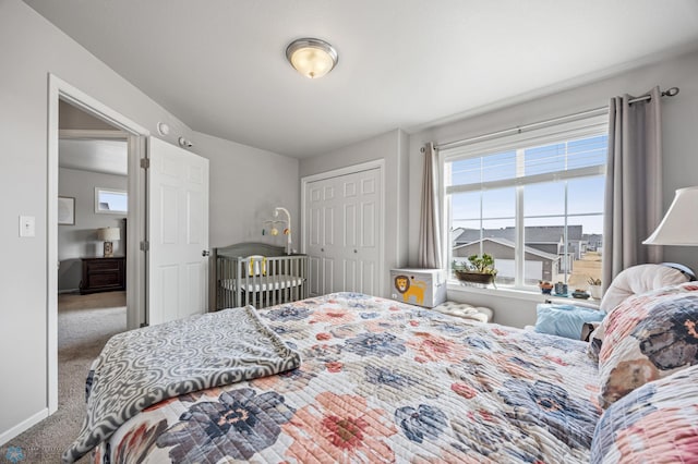 bedroom featuring a closet, carpet flooring, and baseboards