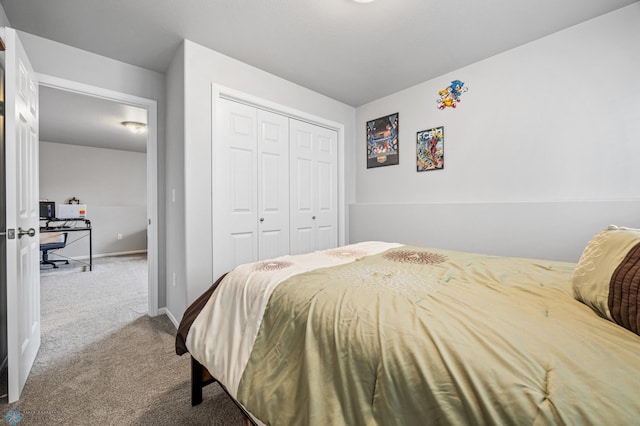 carpeted bedroom featuring a closet and baseboards